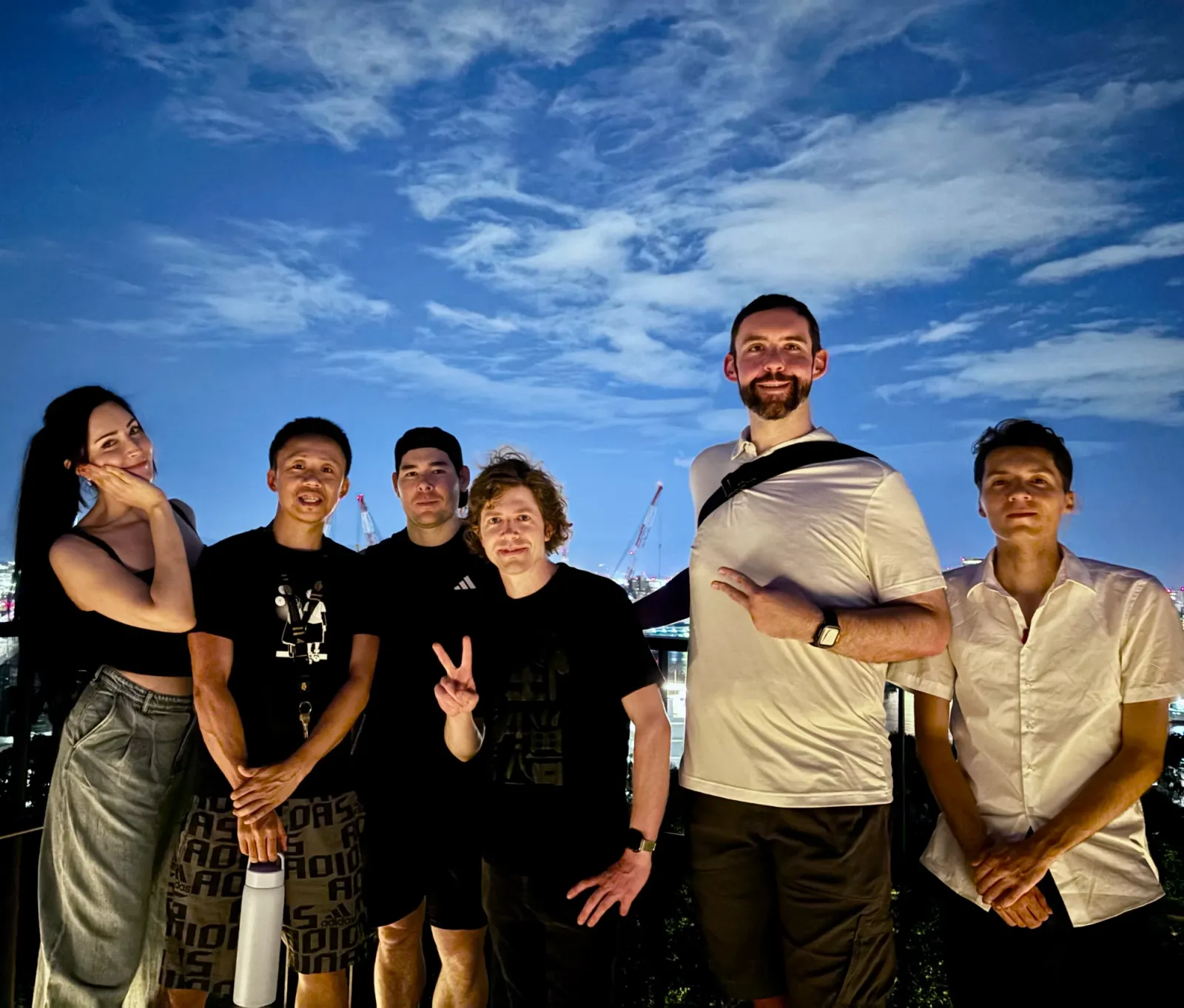Members together by the bay at dusk