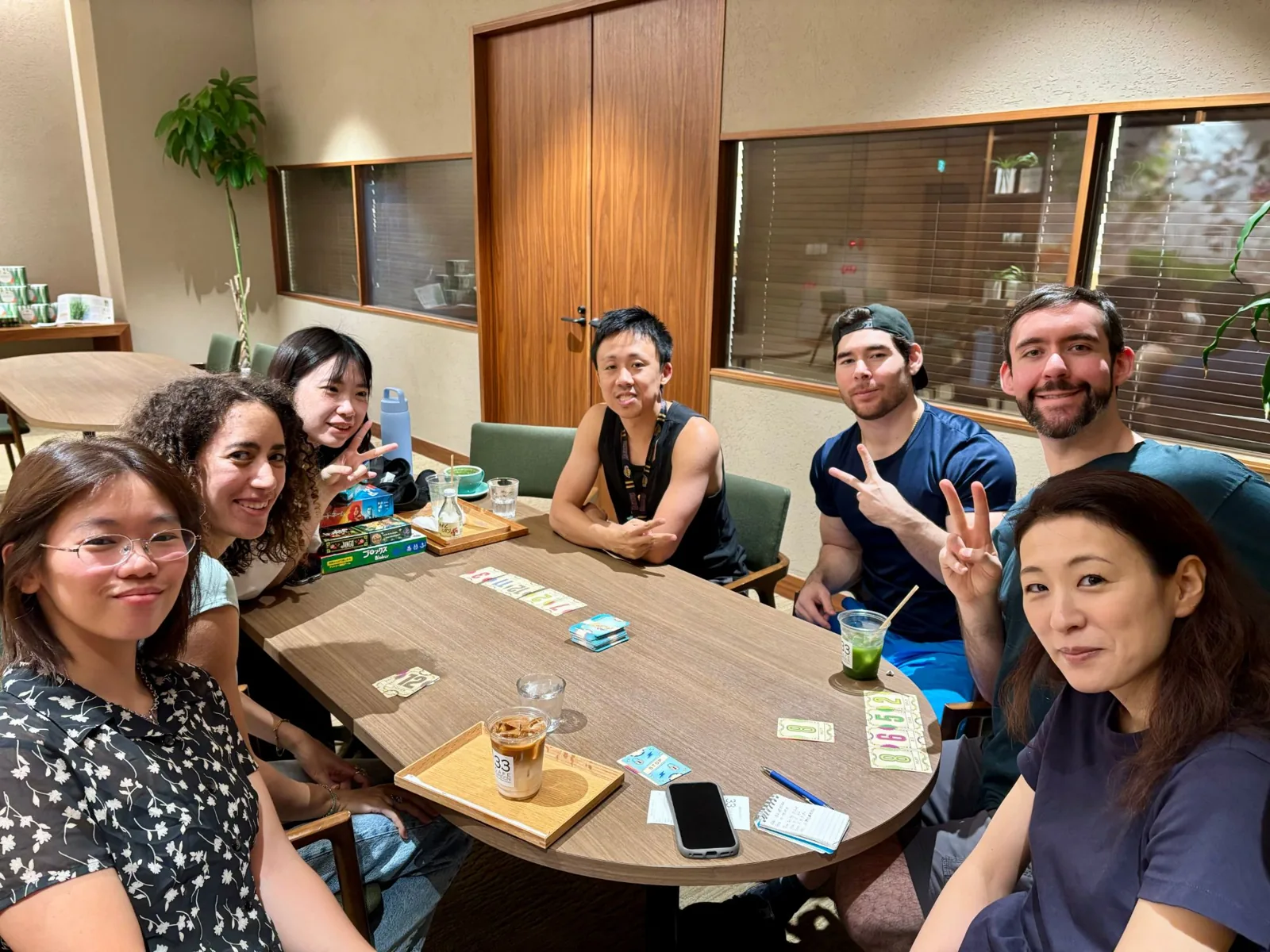 Members playing card games at a café